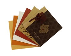 Indian wedding card in brown and golden with ribbon