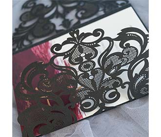 Black colour gate fold laser cut wedding invite with a golden bowknot