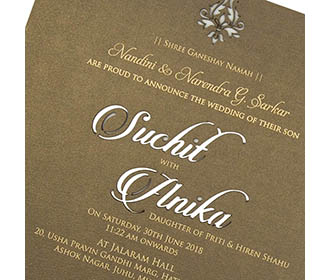 Brown colour invite in cardboard with cut out of couple names