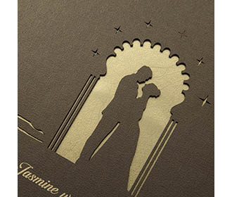 Brown colour Wedding Invite in cardboard with a cut out of a couple