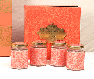 Designer Indian wedding box invite & sweet jars in pastel orange colors