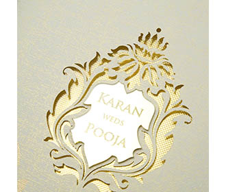 Designer wedding invitation in parchment colour with floral cut outs