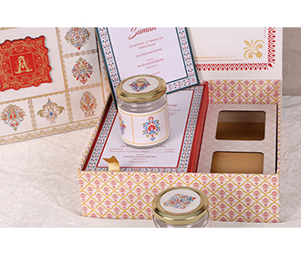 Ethnic Indian wedding invitation box with sweet jars