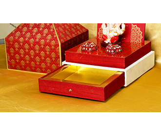 Exquisite Ganesha temple theme wedding invite in maroon colour
