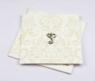 Hindu wedding invitation in off white with floral motifs in peach