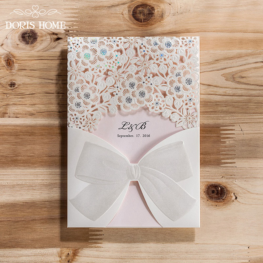 Laser Cut White Floral Wedding Invitation with a bow knot design