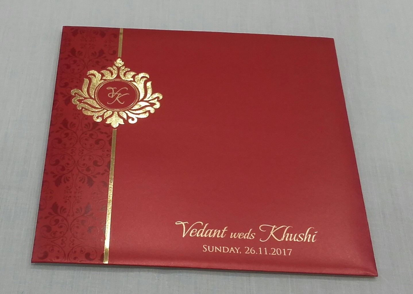 Red and gold invite with laser cut religious sikh symbol