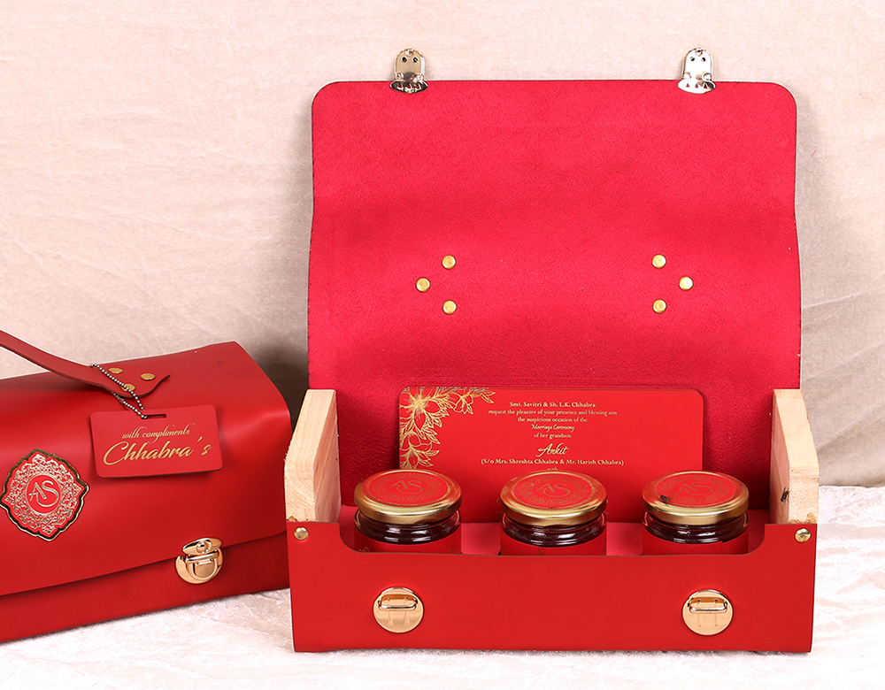 Red color wedding inserts and sweet jars in a bag like box