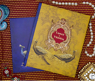 Peacock themed royal indian wedding card in blue