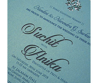 Turquoise blue invite in cardboard with cut out of couple names